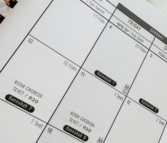 Interior monthly calendar spread with Hebrew and Gregorian dates, Hannukah and Rosh Chodesh marked